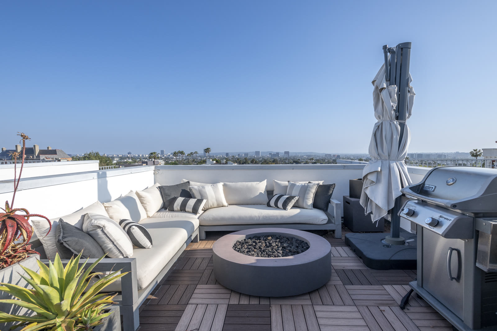 Rooftop lounge seating and fire pit at dusk light